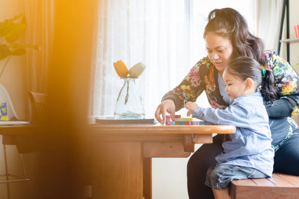istock Mother playing with kids at home. 970840594