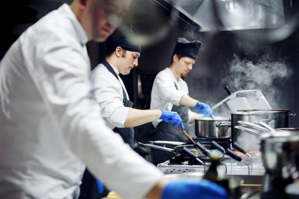 istock Group of chefs working in the kitchen 970840668