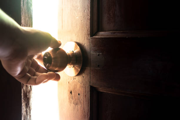 istock Use your hand to open the door to the light. 970843048