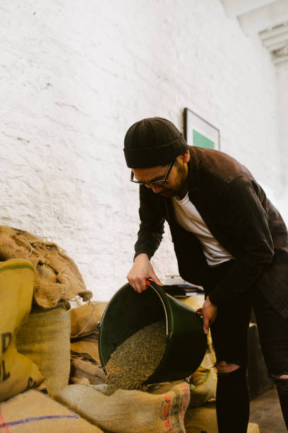 istock Asian man pouring coffee beans. 970846374
