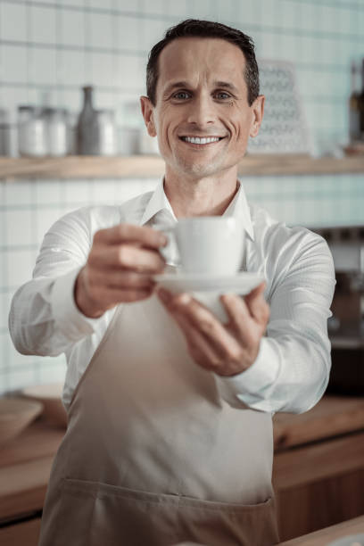 istock Pleased brunette demonstrating cup with drink 970853128