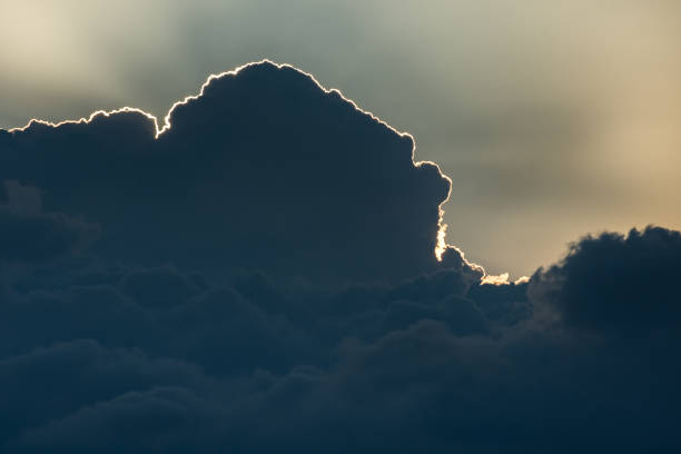istock Sun hidden behind dark clouds on sunset. Ray of light. Copy space. Background. 970853882