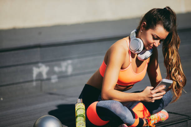 istock Woman sitting and taking a rest from exercising. 970857596