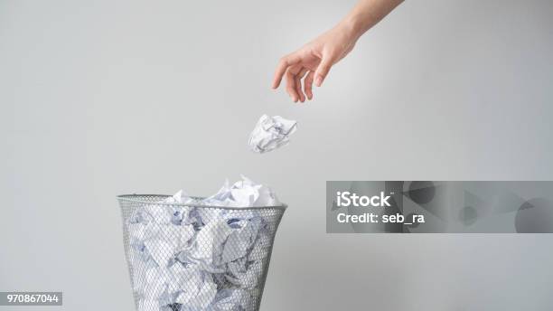 Woman Hand Throwing Crumpled Paper In Basket Stock Photo - Download Image Now - Garbage, Paper, Throwing