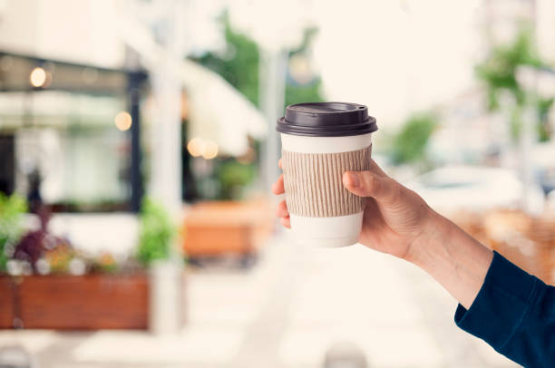 istock Hand holding paper coffee glass 970867946