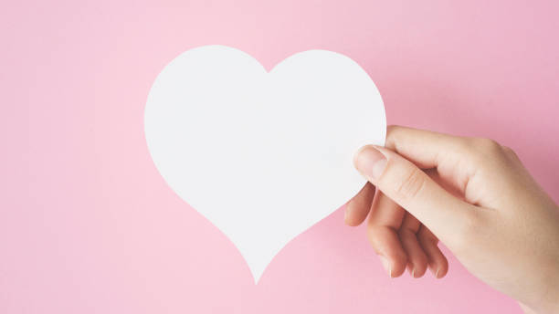istock Hand holding heart shape card 970868054