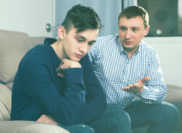 istock Adult man is asking forgiveness from his sad son after conflict 970868328