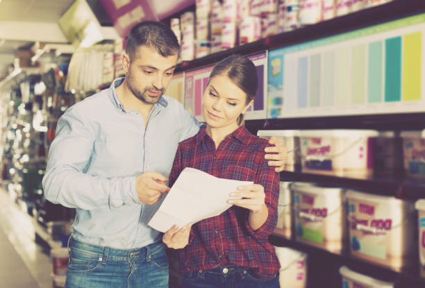 istock couple is choosing color for paint with shop list 970872106