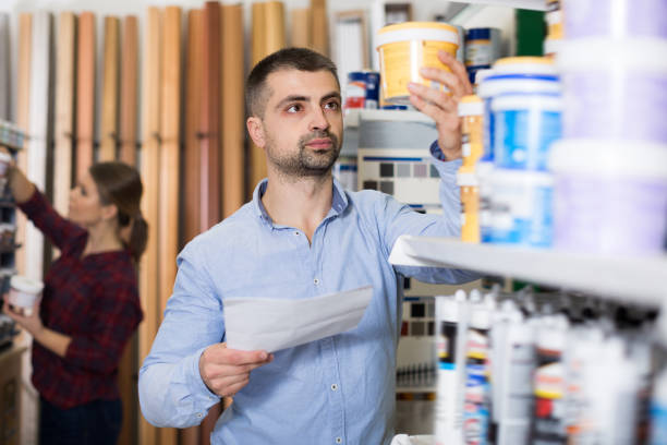 istock Young man designer is choosing paint with list 970872120