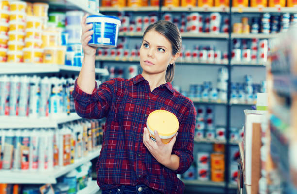 istock Woman is choosing with paint for repair 970872196