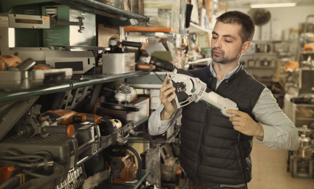 istock Adult male is looking on new grinder in tools store. 970872906