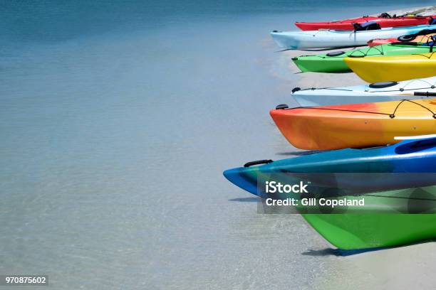 Eight Colorful Canoes Kayaks In A Line On A Tropical Beach Stock Photo - Download Image Now