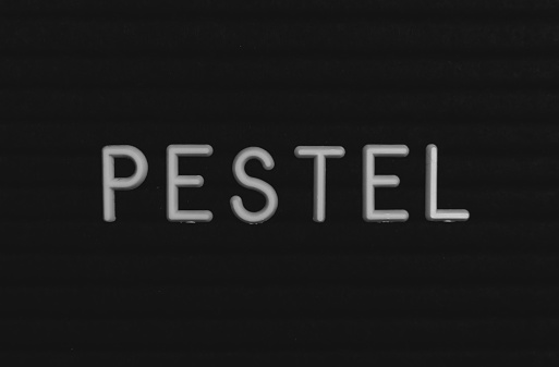 Word pestel written on the letter board. White letters on the black background