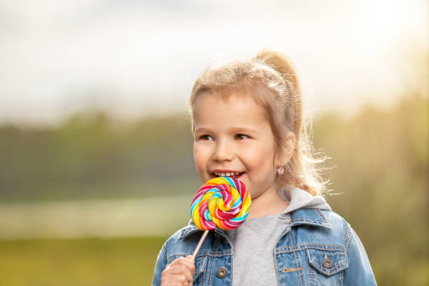 istock Smiling little girl with lollipop 970892764