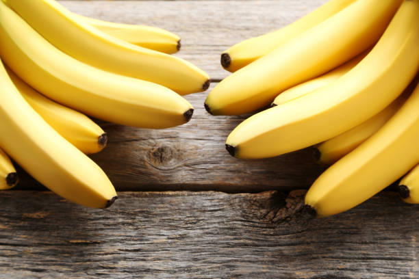 istock Sweet bananas on grey wooden table 970896216