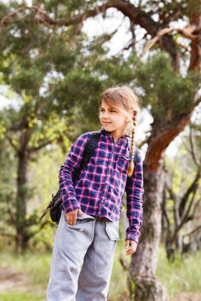 istock Little girl with backpack traveling in the forest 970899954