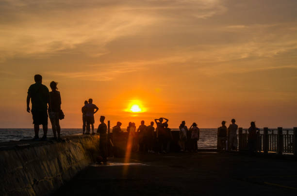 istock Crowd watching the sunset over the sea 970903976