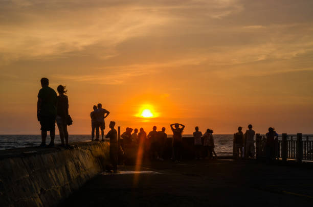 istock Crowd watching the sunset over the sea 970904030
