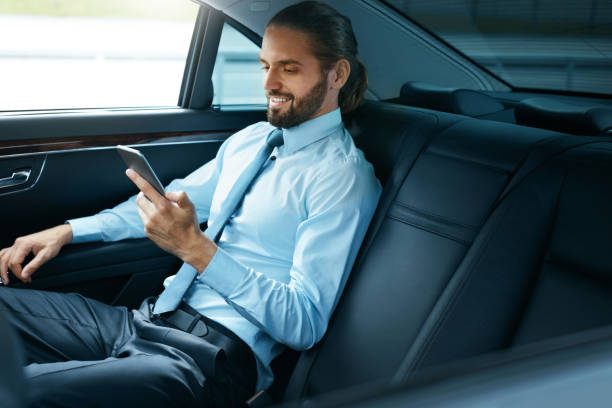 istock Young Successful Man Working On Phone Sitting In Car. 970915684