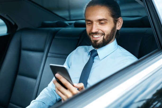 istock Young Successful Man Working On Phone Sitting In Car. 970915826