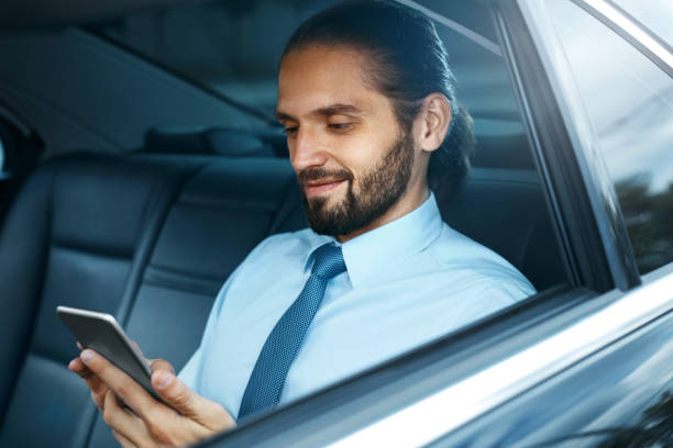 istock Young Successful Man Working On Phone Sitting In Car. 970915902