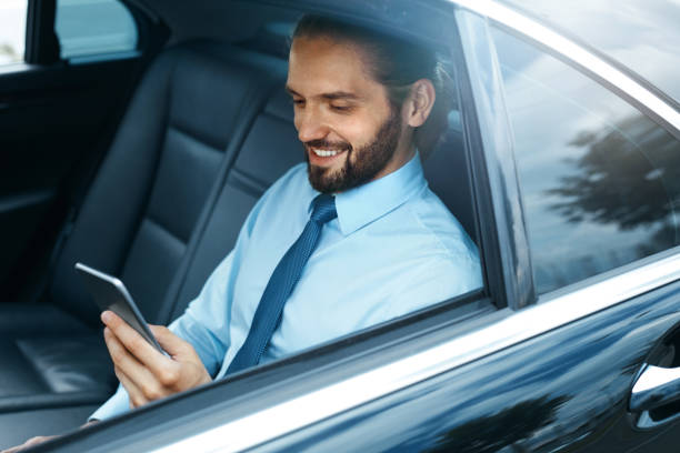 istock Young Successful Man Working On Phone Sitting In Car. 970915984