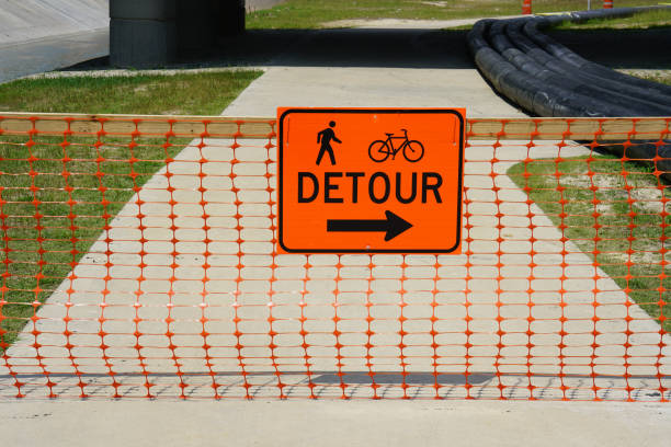 A large detour sign directs traffic away from a construction site.