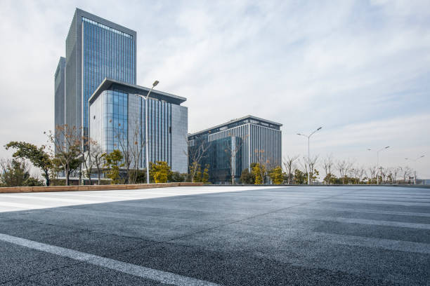 istock modern business office buildings with empty road,empty concrete square floor 970917268