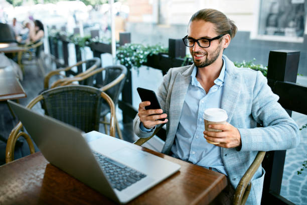 istock Man With Phone Drinking Coffee In Cafe 970919874