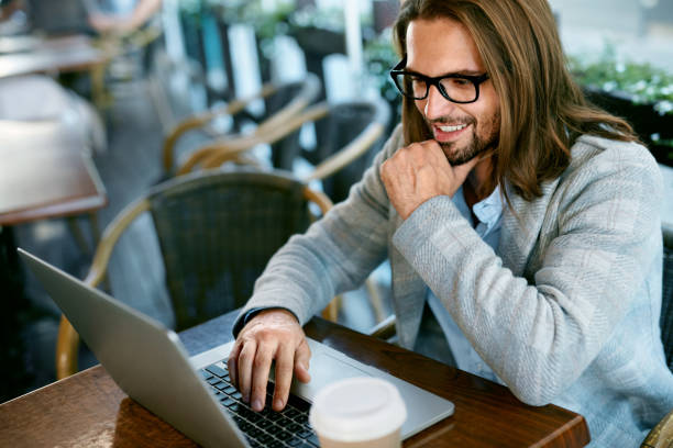 istock Man Working On Notebook From Cafe Outdoors 970919990