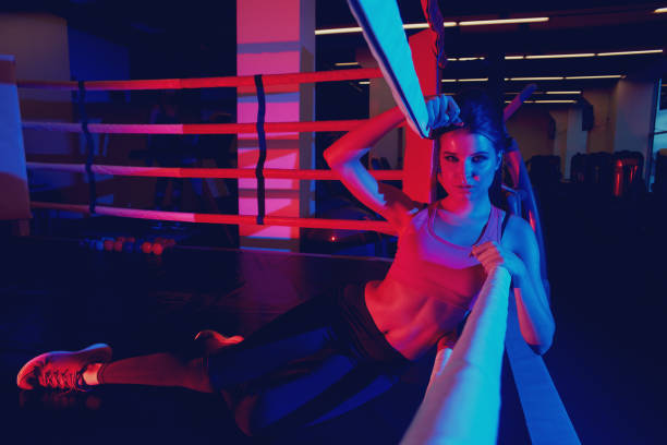 istock Woman in sportswear lying on boxing ring 970920004