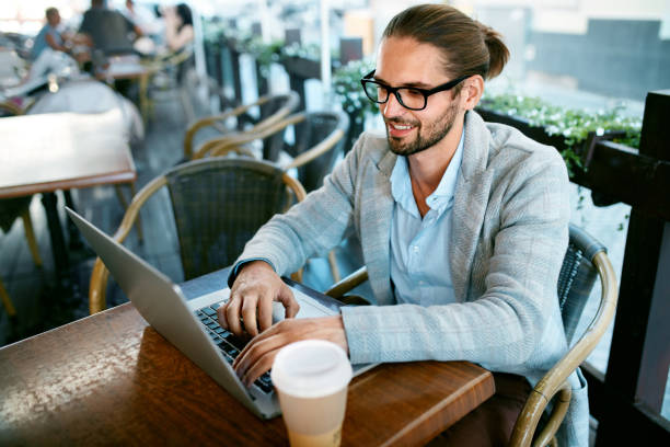 istock Man Working On Notebook From Cafe Outdoors 970920072