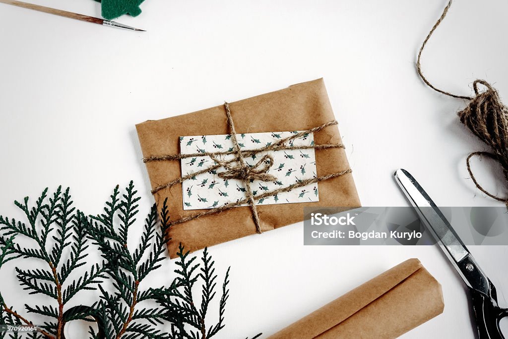 Simple Christmas Card And Gift In Craft Paper Rustic Handmade Presents Toys  Essentials On White Background Seasonal Greetings Space For Text Stock  Photo - Download Image Now - iStock