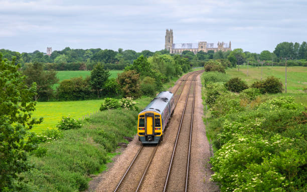 railway train in rural landscape with minster, beverley, yorkshire, uk. - local train imagens e fotografias de stock