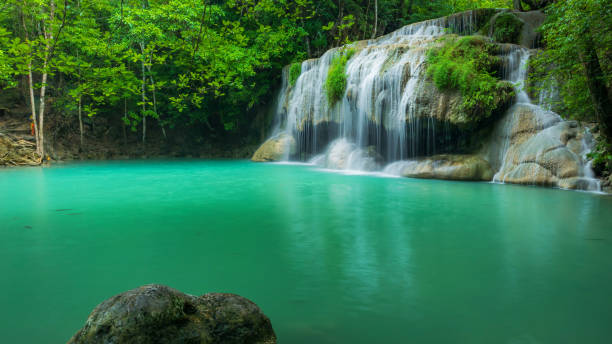 breathtaking green waterfall at tropical rain forest, erawan waterfall located kanchanaburi province, thailand - thailand heaven tropical rainforest forest imagens e fotografias de stock