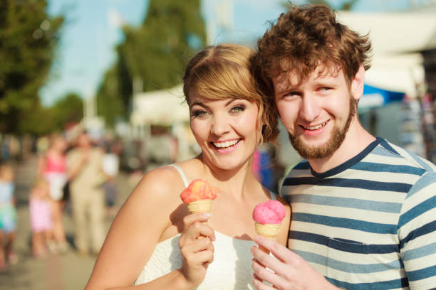 istock young couple eating ice cream outdoor 970936412