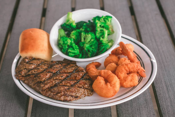 surf and turf - surf and turf prepared shrimp steak grilled fotografías e imágenes de stock