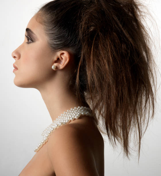 istock brunette woman profile with pearl necklace 970938228