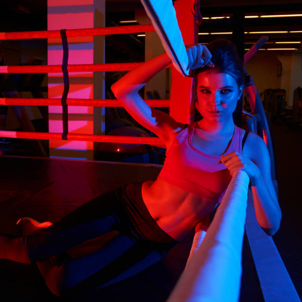 istock Woman in sportswear lying on boxing ring 970942200