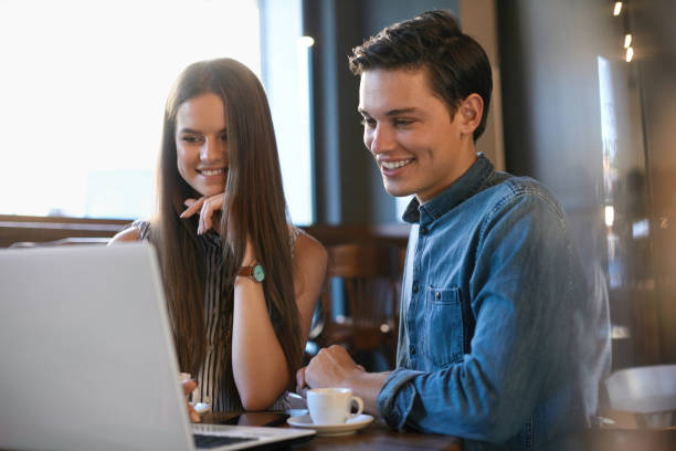 istock Beautiful Couple Working On Notebook In Cafe. 970948222