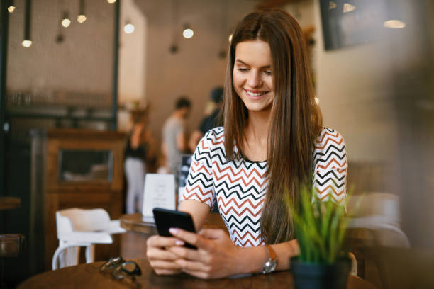 istock Beautiful Woman With Phone In Cafe. 970948644
