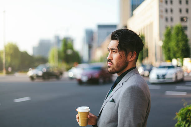 istock Young businessman waiting at traffic lights 970957342