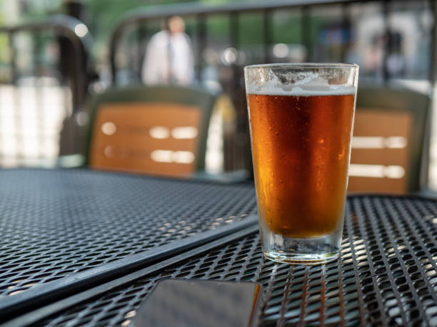 istock Frosty beer glass sitting on outdoor patio table 970957916