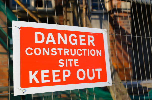 istock Building site with scaffolding, and site fencing with sign 