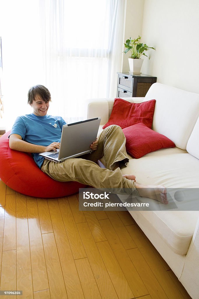 Casual guy sitting confi on the net  Adult Stock Photo
