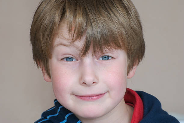 istock 4 year-old boy smirking, blue eyes, brown hair 97097327