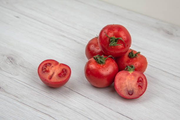 istock Red tomatoes on the white wood table 970977544