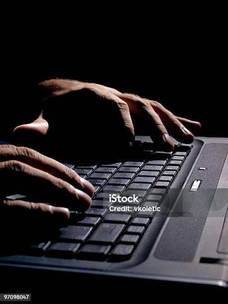 Hands On A Black Laptop Keyboard In The Dark Stock Photo - Download Image Now - Criminal, Searching, Computer Keyboard