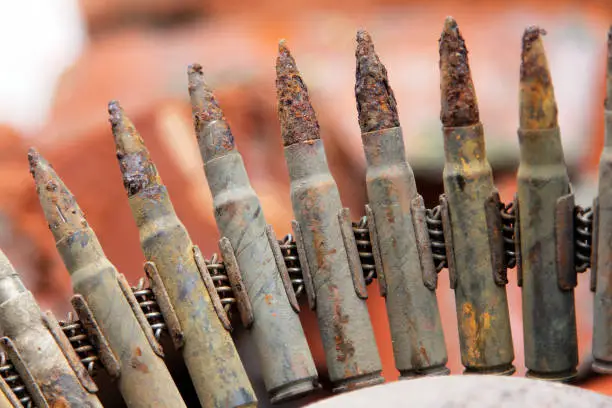 Old rusty machine gun belt with cartridges closeup