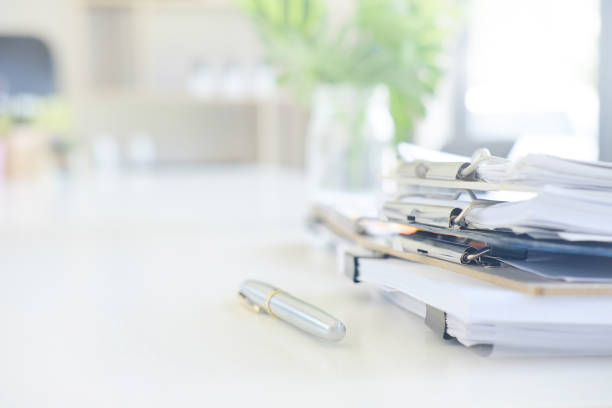 istock Stack of paper files and pen business equipment on office table. 970994762